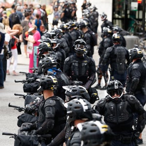 Demonstrators march by police during the Shut Down Trump & the RNC protest on July 17 in Cleveland.