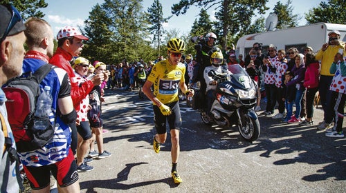 Chris Froome running after being involved in a crash after he ran into back of a motorbike that had stopped due to the large crowds.
