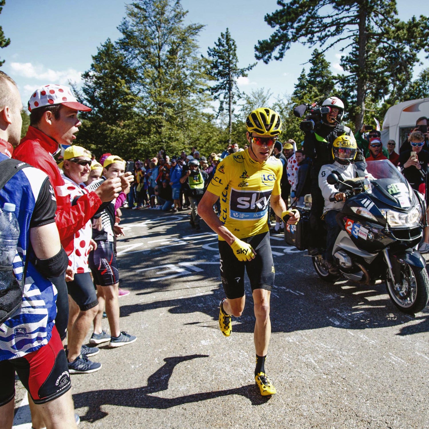 Chris Froome running after being involved in a crash after he ran into back of a motorbike that had stopped due to the large crowds.