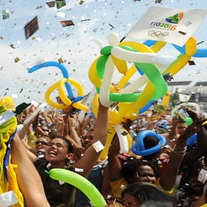 A cheerful crowd roars of joy in Copacabana Beach in Rio de Janeiro, Brazil as it is officially announced that their hometown will stage the 2016 Olympic Games, October 2, 2009. Rio de Janeiro's dream of bringing the Olympics to South America for the first time became reality here on Friday when they won the vote to host the 2016 edition. The Brazilian city saw off Madrid - by 66 votes to 32 - in the final round of voting after odds-on favourites Chicago, backed by a personal visit from President Barack Obama, had gone out in a first round sensation.   AFP PHOTO/VANDRLEI ALMEIDA (Photo credit should read VANDERLEI ALMEIDA/AFP/Getty Images)