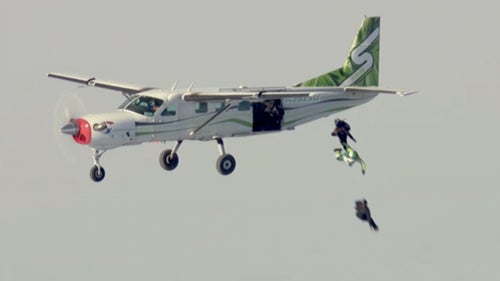 Once Aikins (in green) exited the plane, the only way he was going to survive was if he hit his target. He wore an oxygen mask for the first 10,000 feet of freefall, handing it to Farrington around 15,000 feet altitude.