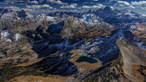 Grand Teton National Park, while not particularly enormous in surface area, has a tremendous density and variety of terrain, from glaciers to massive lakes, and of course Grand Teton herself (13,770鈥, right horizon). On this particular flight after some early season snowfall, I decided to head into the difficult-to-reach northwest corner of the park to photograph scenes that few visitors will ever see. What I had to get over was the worry of an in-flight emergency in this wilderness, though the resulting photography was every bit worth it.
