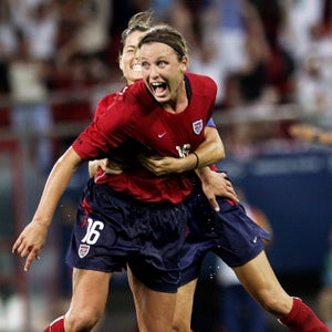 GREECE - AUGUST 26:  Abby Wambach of the U.S. is hugged by a teammate after scoring the game-winning goal in overtime against Brazil in the women's soccer gold medal match at Karaiskaki Stadium during the 2004 Summer Olympic Games in Athens. Mia Hamm (right) runs over to join the celebration, as Brazil's Marta looks on.  (Photo by Ron Antonelli/NY Daily News Archive via Getty Images)