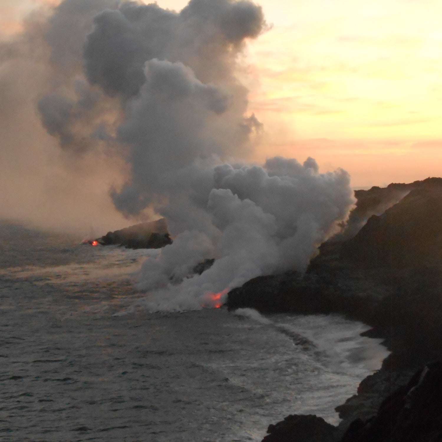 Lava Flowing into Pacific Ocean on Big Island, Hawaii during Sunset.