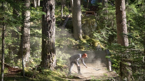 Local trail builder Scott Veach touching up the landing to the opening feature on Salsa Verde.