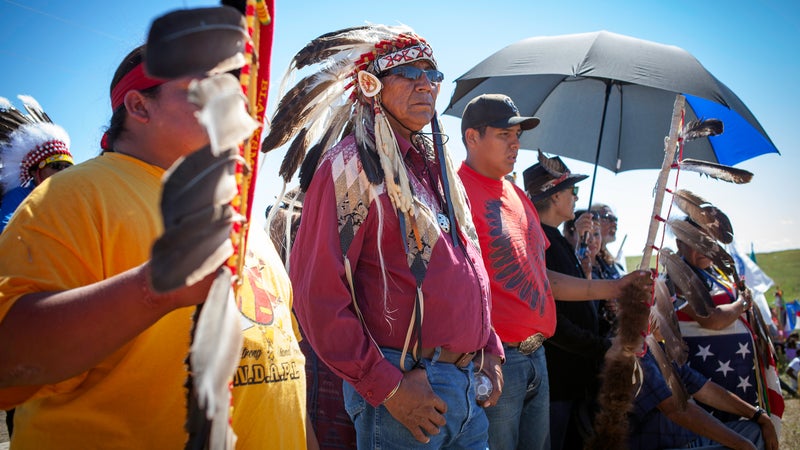 Chief Arvol Looking Horse, leader of the Lakota Sioux Nation stands nearby Apache musician Robby Romero and AIM co-founder Dennis Banks witnessing a drum-circle near the construction blockade at Standing Rock. 8/27/16