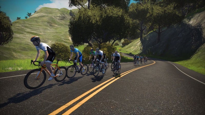 Zwift riders head uphill on Watopia.