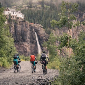 Spend ten days ripping singletrack and fly fishing through Colorado’s San Juan Mountains with a group of your best friends and you might just have a dream vacation. This August, photographer and rider Ben Kraushaar put together a crew of MTB and adventure junkies to do just that. With Telluride as the jumping off point, Kraushaar was joined by Justin Reiter, Dylan Stucki, Sam Simmons, and Trevor Downing for some high country trout, great riding, and plenty of challenging Colorado weather. Here, Kraushaar shares some favorite shots from their San Juan mission. 
Photo: (Left to right) Sam Simmons, Justin Reiter, and Dylan Stucki pedal towards Bridal Veil Falls, the tallest waterfall in Colorado, in Telluride. We started our ten-day bikepacking trip in Telluride with the intention of fishing numerous alpine lakes and streams on our course through the San Juan Mountains.