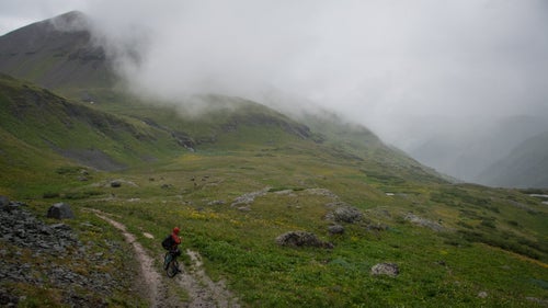 Stucki watches as the next wave of rain makes its way up the valley. For the first five days of our trip we battled through horrendous weather. Cold rain at nearly 13,000 feet, for days on end, makes for an epic journey.