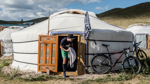 McElveen exits a Mongolian yurt, or 鈥済er,鈥 in one of the camps where the racers stayed. Each ger includes four beds against the walls and a wood stove in the middle.