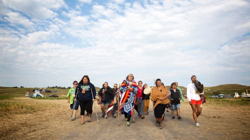 Peggy Wellknown Buffalo of Montana鈥檚 Apsaalooke (Crow) Nation leads a group of women through camp to the banks of the Cannonball River for a ceremony just after dawn. Those who鈥檝e gathered to oppose the pipeline have frequently been described as activists and demonstrators by the media, but many of them argue those terms are inaccurate. They say the camp is a place for peace and prayer, and that they have come to protect, not protest.