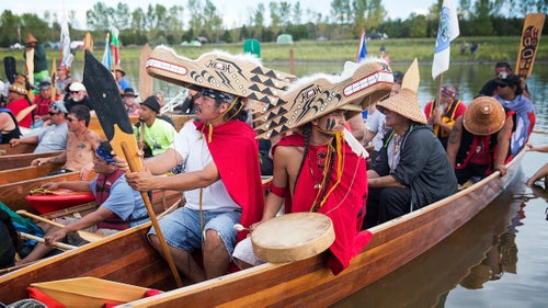 Marco Black (left) and Micah Masten of the Quinault Indian Nation in Washington State wear wolf masks during a ceremony on the banks of the Cannonball River near the protest encampment. The Quinault Tribe, along with paddlers from tribes across the Pacific Northwest and elsewhere, had just canoed down the Missouri from Bismarck, the North Dakota Capitol.