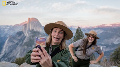 At Yosemite’s Glacier Point, rangers Diana del Solar and Christina Warburg pose for a selfie to post to a Department of the Interior Snapchat account.