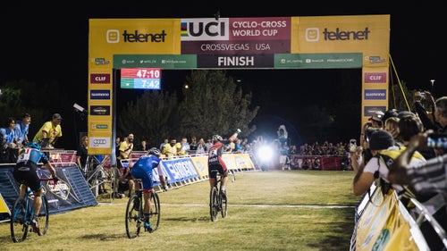 Pro rider Sophie De Boer of the Kalas-H.Essers-NNOF Cycling Team raises her arm to celebrate her win.