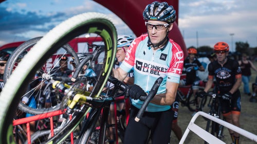 A racer pushes his bike to the call-up for the Wheelers and Dealers field.