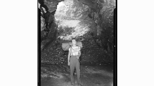 A hiker from Two Rivers, Wisconsin, takes a gander at the historic entrance of Mammoth Cave in 1941.