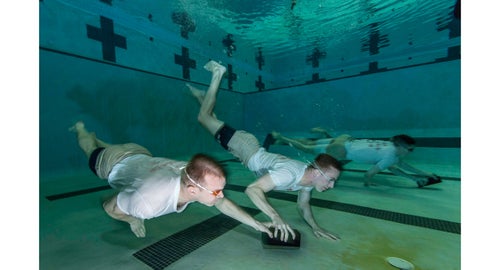 AN Fuller and AN Everette (foreground team) and AN Neaves and AN Rotz (background team) perform a water-confidence drill called