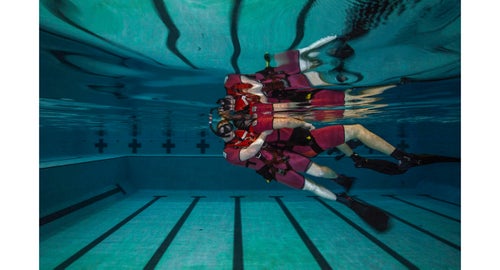 Class 119-16. AN Tyler Sojka 鈥渂uddy towing鈥 his partner, AN Anthony Troche. Sojka's hip is placed into the small of the survivor's back, and with a fast, forward kick, the survivor is raised to the water's surface.