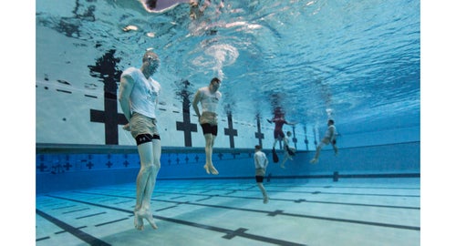 Airman (AN) Steven King (left) and AN Eli Haynie (middle) perform a water-confidence drill called