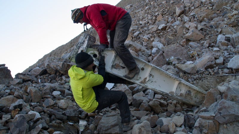 Digging out a metal beam.