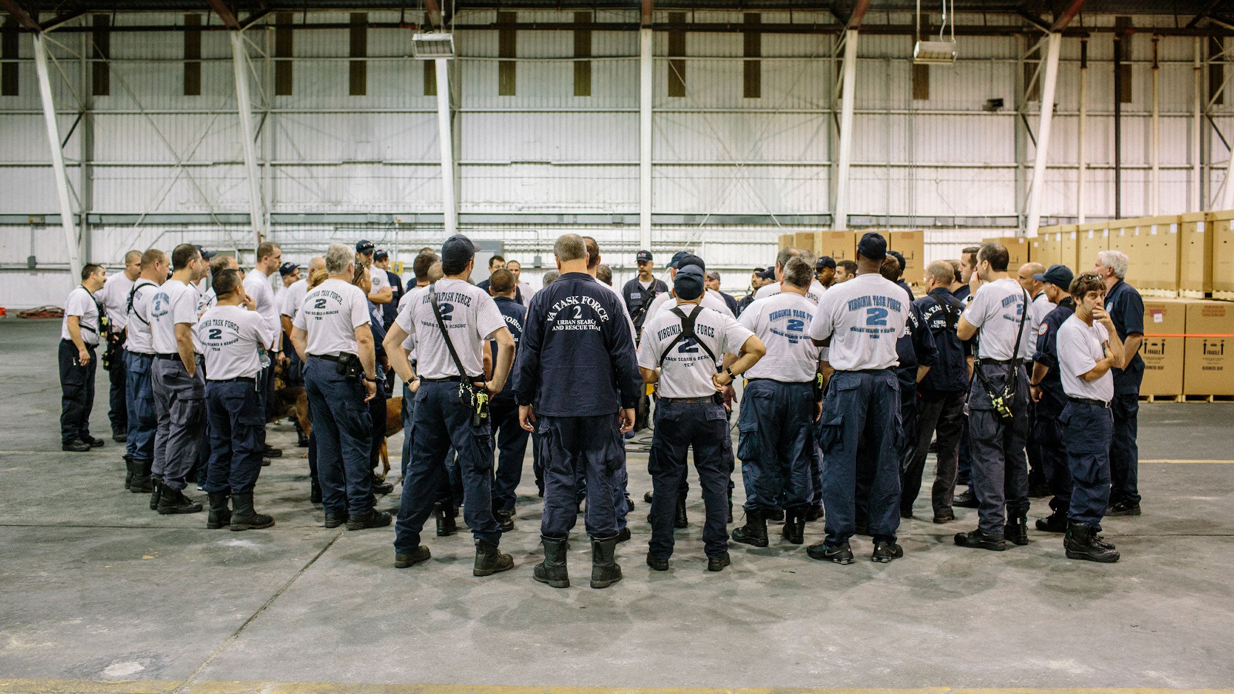 Members of Virginia Task Force 2 stand for an early morning briefing during Hurricane Matthew.