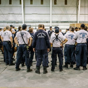 Members of Virginia Task Force 2 stand for an early morning briefing during Hurricane Matthew.