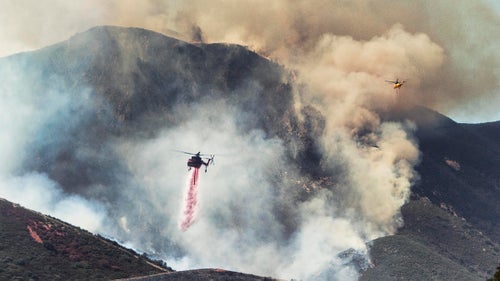 Helicopter cranes dump retardant on the Soberanes Fire (2016) in California’s Los Padres National Forest.