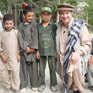 Greg Mortenson with village children in Khaplu Valley, Pakistan.
