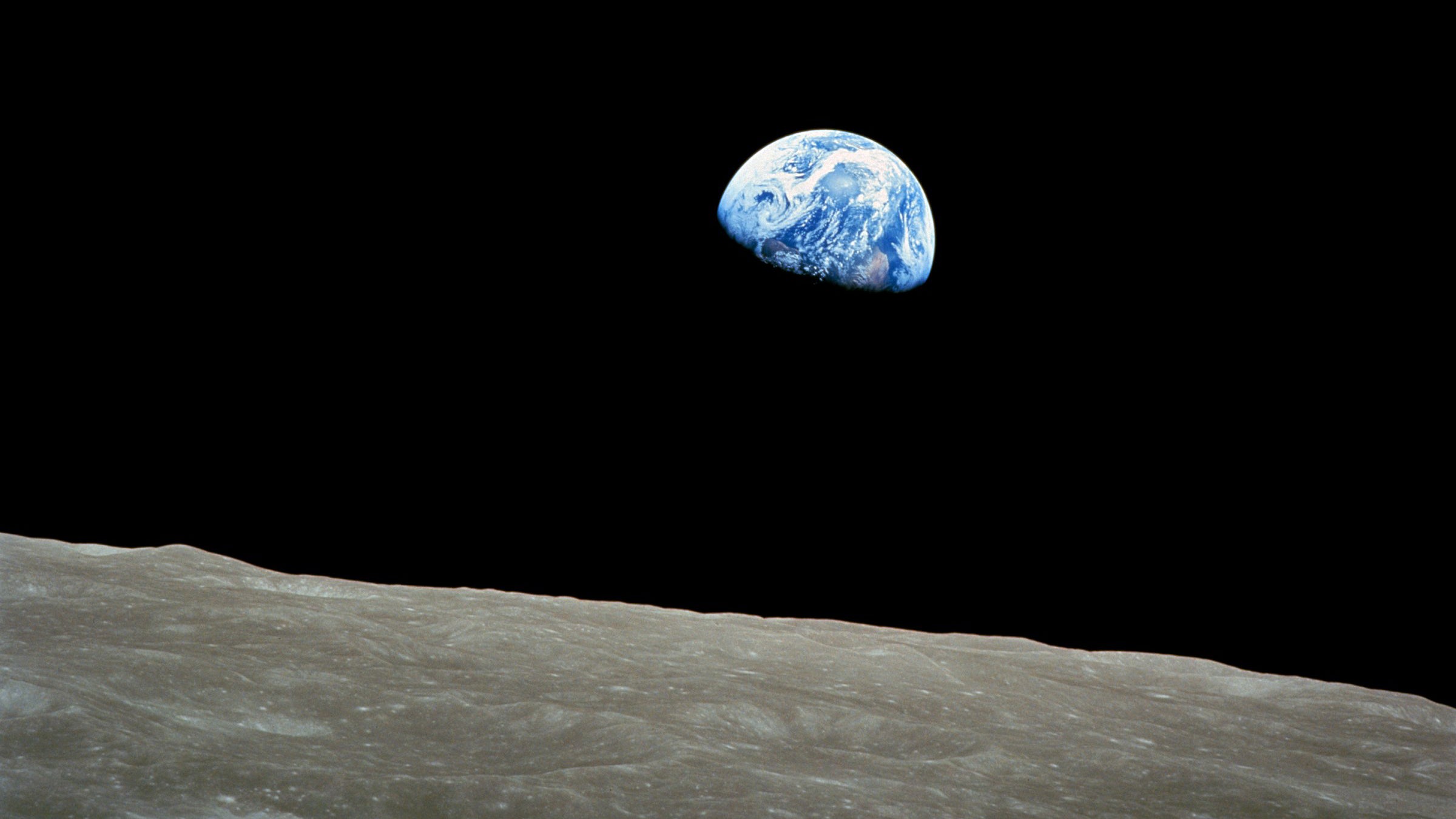 The "earthrise" view from Apollo 8, photographed in 1968, has been called one of the most influential environmental photographs ever taken. David Biello introduces his book, 'The Unnatural World,' with the scene.