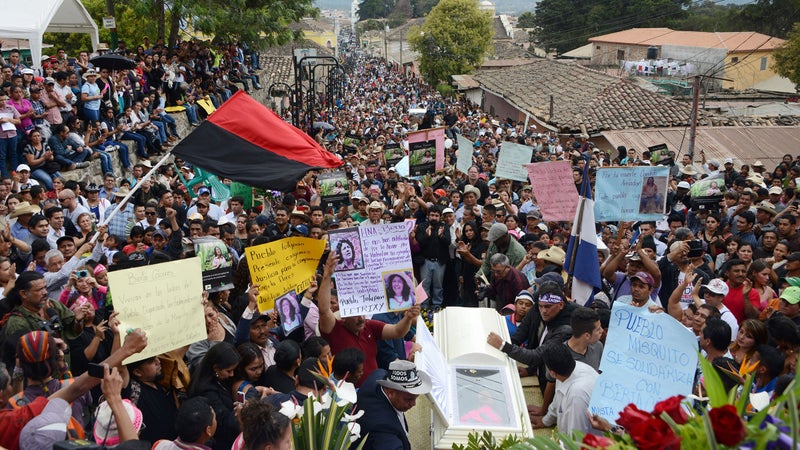 Cáceres’s coffin being carried through the streets.