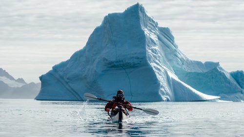 Andrew paddles a folding Oru kayak through a fjord in eastern Greenland.