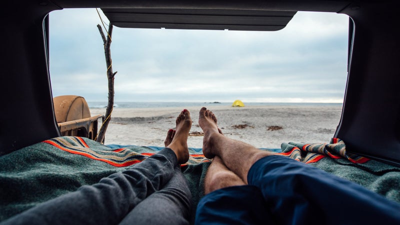 two people living in a car relaxing