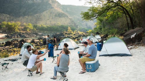 Massive fluctuations in river levels often push white sands high above the riverbank, as seen at the first camp, near Rapid 21. There, the group recounted a big day on the river—for some, it was their first whitewater experience.