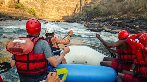 Big change may be coming to Africa’s fourth-largest river. While commercial outfitters have been running trips on the Zambezi since 1982, the river may soon be impassable, as the governments of Zambia and Zimbabwe continue to discuss a proposed dam construction below Victoria Falls. To get ahead of the $3 billion project, British Columbia–based outfitter ROAM (Rivers, Oceans, and Mountains) is offering rafting adventures through the Batoka Gorge, the area due to be dammed, allowing visitors to enjoy the Zambezi while it’s still wild.
Last October, I joined Brian McCutcheon and raft guide “Hippo” Moses Ngoma to see the river firsthand. Our expedition warmed up with a two-day “ducky” canoe float down some easier rapids above Victoria Falls, one of the seven wonders of the natural world. This was followed by three days of real-deal rafting over 34 miles and through 30 large rapids, including Class V passages with names like the Gnashing Jaws of Death, Oblivion, and Open Season.