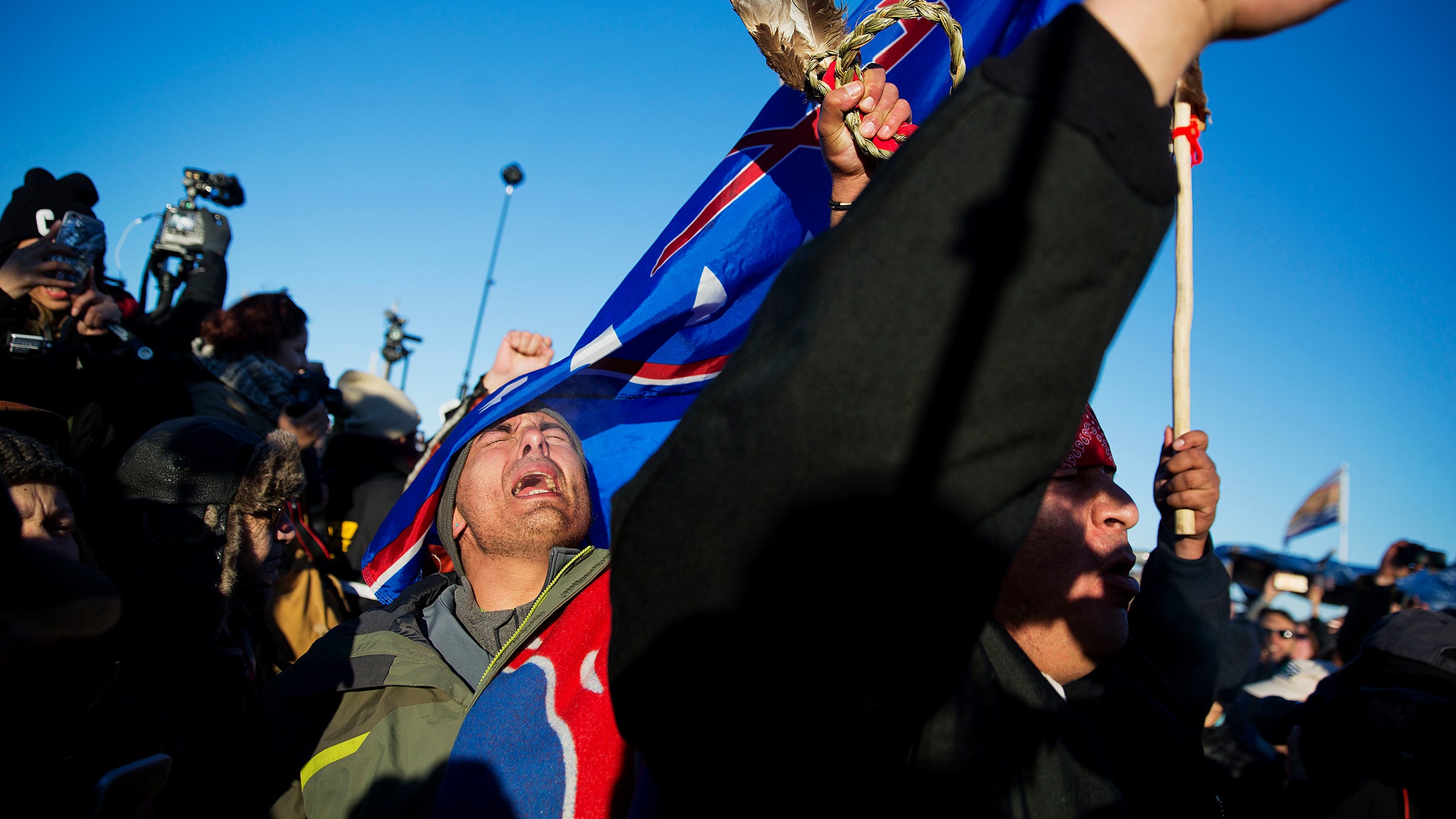 Bobby Robedeux (left) and Adrian SpottedHorseChief react to the Army Corps announcement on December 4. 