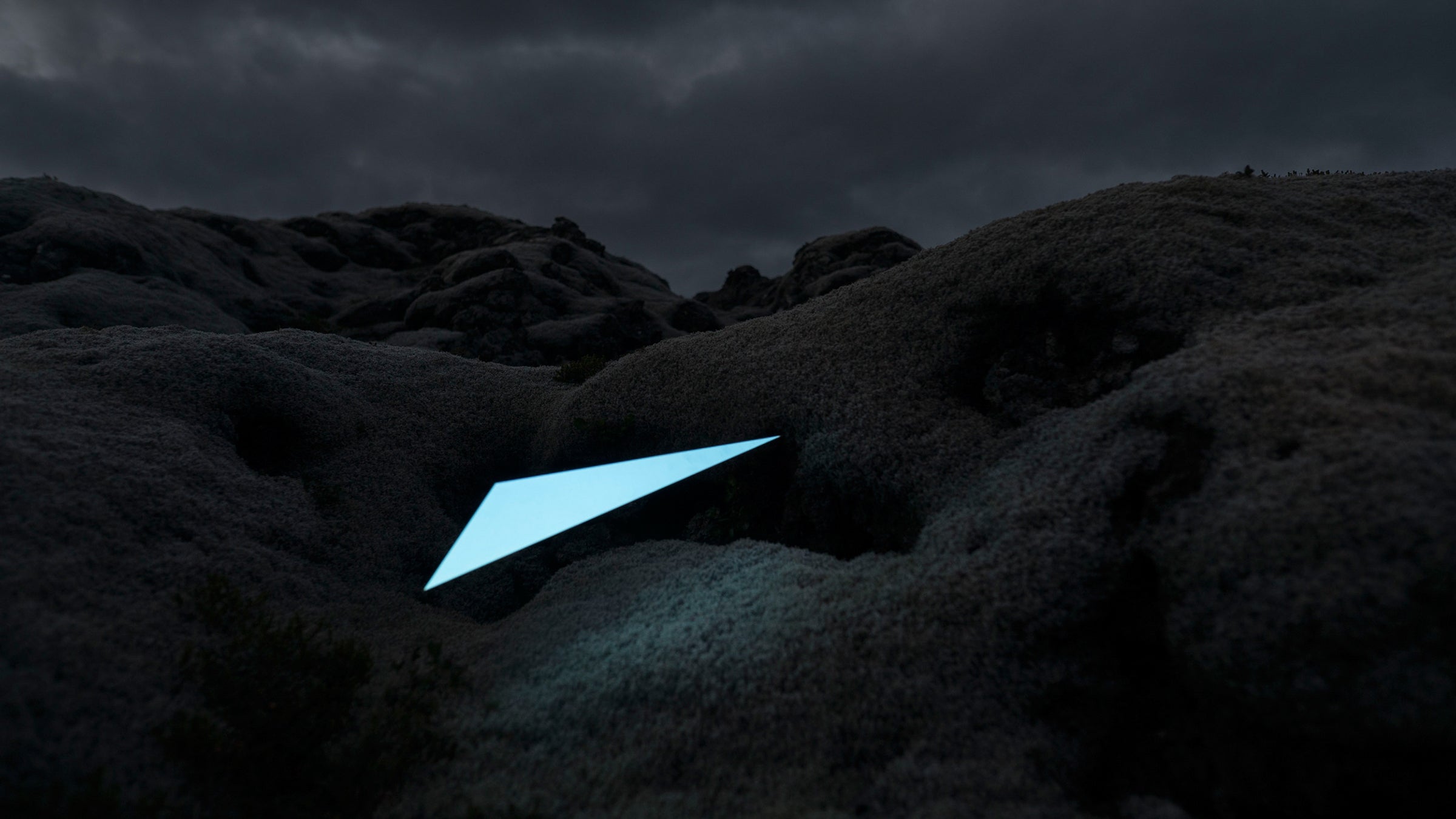 For installations like this, the photographers used a thin carbon stick attached to cardboard, then lit it using a normal projector. 
