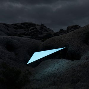 For installations like this, the photographers used a thin carbon stick attached to cardboard, then lit it using a normal projector.