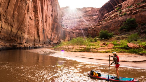 This May, five adventurers pushed off below the bridge at Highway 12 in southern Utah to navigate a 100-mile stand-up paddleboard first descent on the Escalante River, which drains into Lake Powell. The caravan, composed of Dylan Brown, Morgan Tilton, Jordan Curet, Morgan Smith, and Aaron Kloer鈥攁ll seasoned outdoor explorers but novice boaters鈥攎ade hundreds of hook turns for six days through Grand Staircase-Escalante National Monument鈥檚 soaring Navajo sandstone. The gorge reached heights of more than 1,000 feet and greeted the crew with boulder-strewn whitewater.
Here, Morgan Tilton takes us through a few of Dylan Brown's favorite shots from the trip.
Photo: Tilton admiring one of the many stunning horseshoe bends in a series of progressively taller, more pronounced 180-degree curves near the halfway point on the Escalante. She rode the inflatable Hala Gear Straight Up, which is durable and stable, with fully removable fins and well-placed reinforced stainless D-rings for strapping down gear.