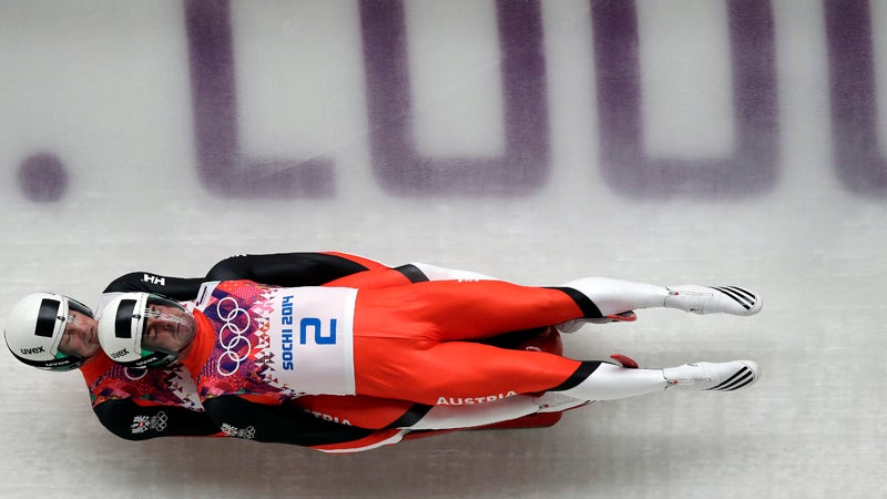 The doubles team of Andreas Linger and Wolfgang Linger of Austria speed down the track in their final run during the men's doubles luge at the 2014 Winter Olympics, Wednesday, Feb. 12, 2014, in Krasnaya Polyana, Russia. The team won the silver medal. (AP Photo/Michael Sohn)