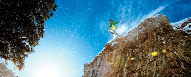 Jacqui Edgerly jumping a large cliff in the Snowbird sidecountry.