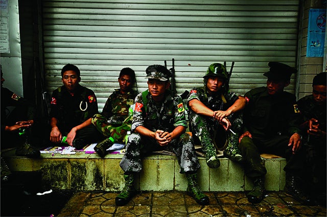 Just back from the front Kachin  Independence Army soldiers take a rest in front of the Laiza hotel