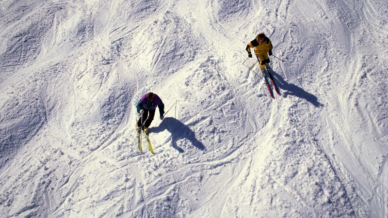 Two men skiing bumps