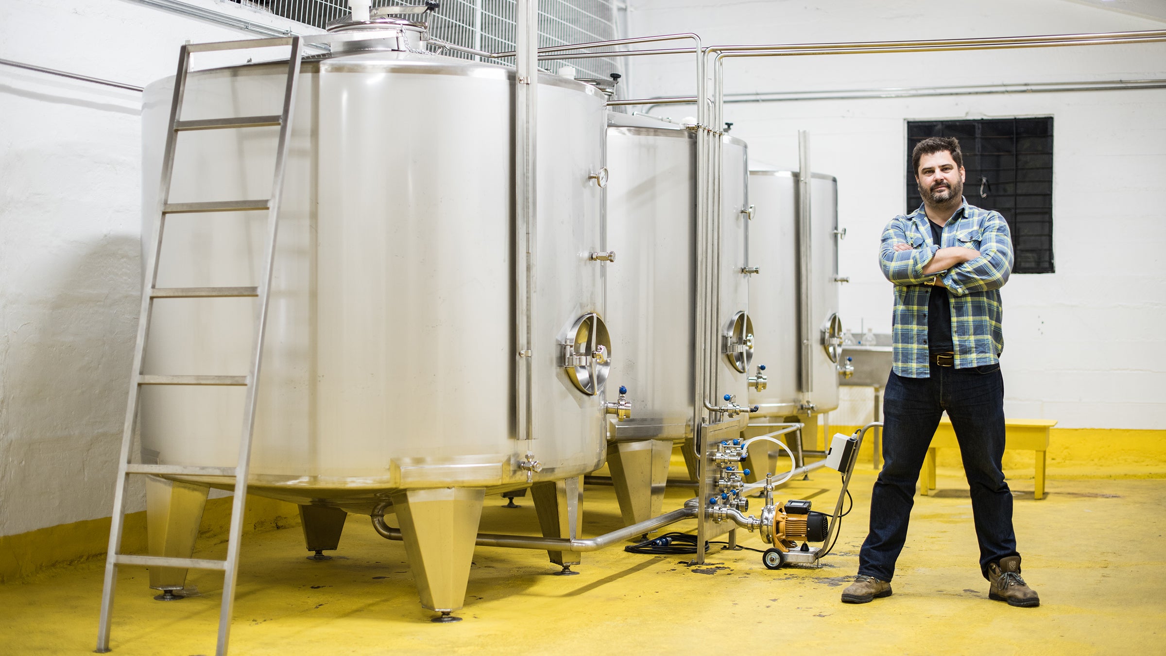 Sebastian Gomez Camorino stands in front of his distillery in Osorno, Chile, where he makes a new clear liquor called Träkál.
