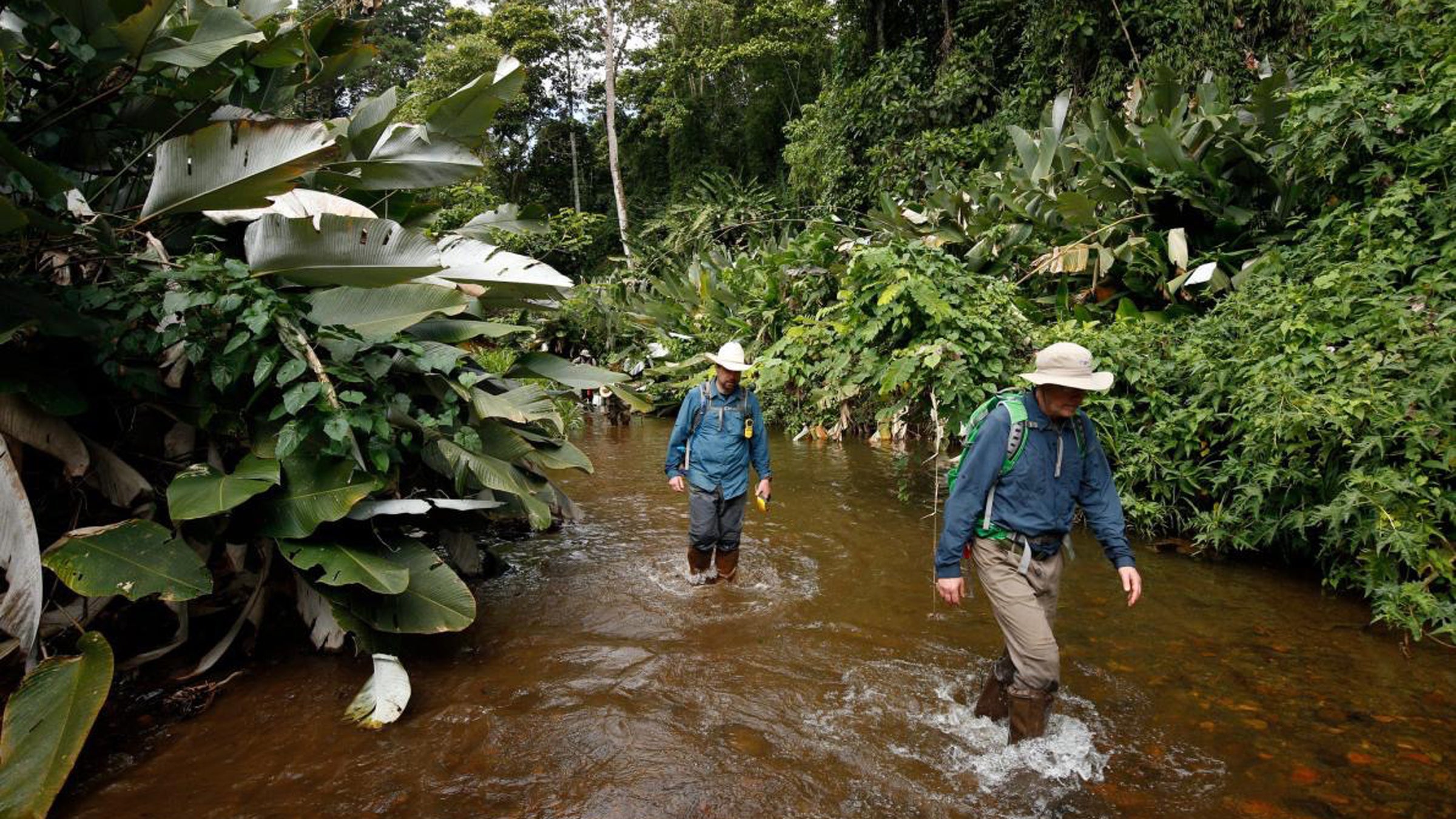 Chris Fisher (behind), the expedition’s chief archaeologist, and the author explore the unnamed river flowing through the valley of T1 below the ruins.