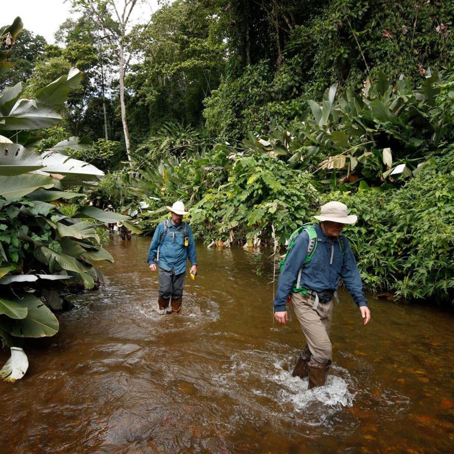 Chris Fisher (behind), the expedition’s chief archaeologist, and the author explore the unnamed river flowing through the valley of T1 below the ruins.