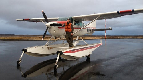 While airborne, Wilson's not only steering the plane but also conducting aerial surveys at the same time.