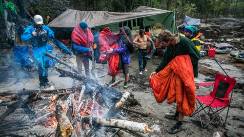 After a couple days of steady autumn rain, the team dried sleeping bags in the smoky heat of the fire at Camp 2 on the Nelson River.