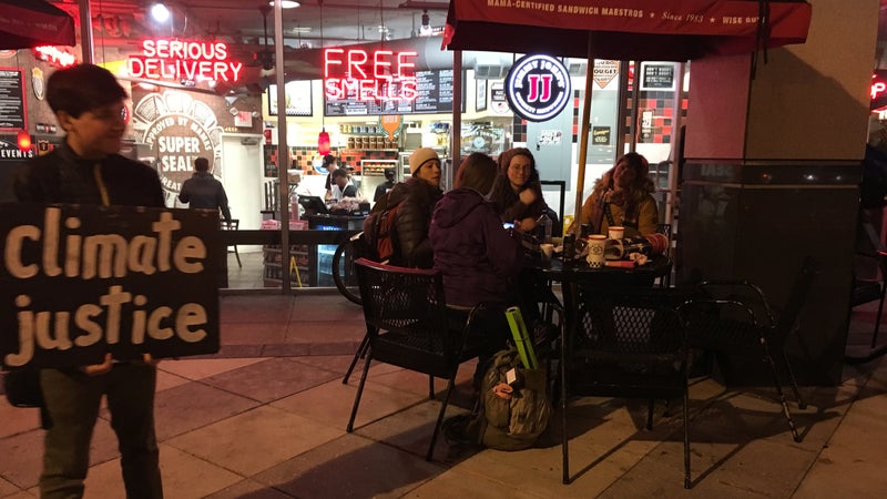 Hatcher, the author's son, protests in front of Jimmy John's.