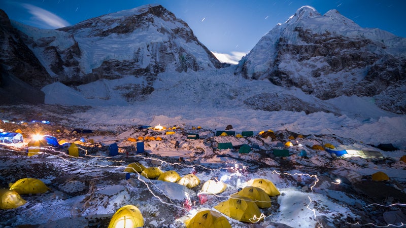 Headlamps trace through the night sky at Everest Base Camp.
