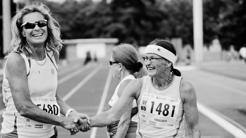 W65 masters track & field heptathletes Ingeborg Zorzi, of Italy, left, and Terhi Kikkonen, of Finland, congratulate each other at the 200-meter finish line in Venissieux, France during the 2015 World Masters Athletics Championships.